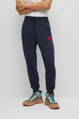 Cotton-terry tracksuit bottoms with red logo label