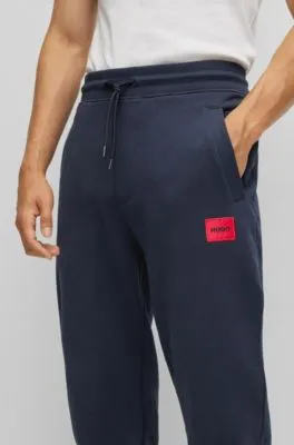 Cotton-terry tracksuit bottoms with red logo label